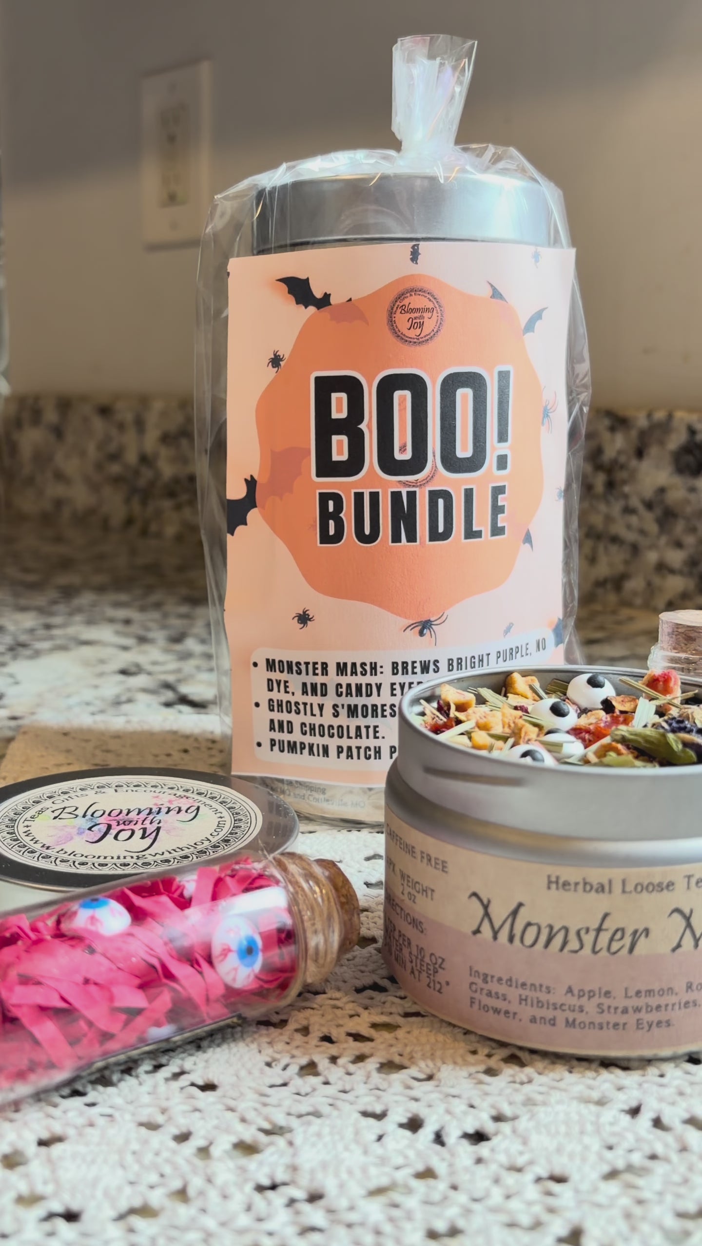 Monster Mash purple butterfly pea flower tea with candy monster eyes in a clear glass mug